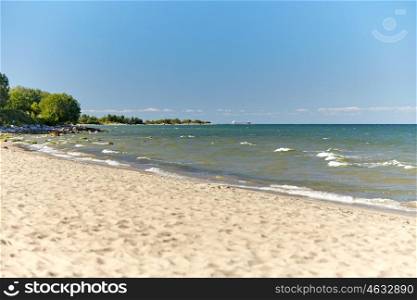 travel, tourism, vacation, seascape and summer holidays concept - baltic sea beach