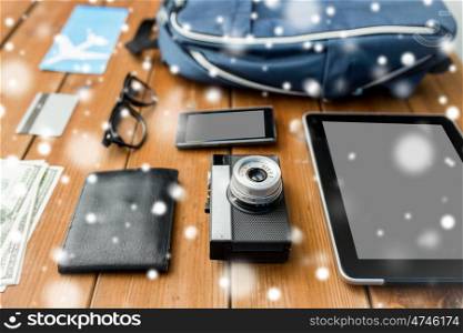 travel, tourism, winter holidays and objects concept - close up of camera, gadgets and personal stuff