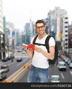 travel, vacation and education concept - travelling student with backpack and book