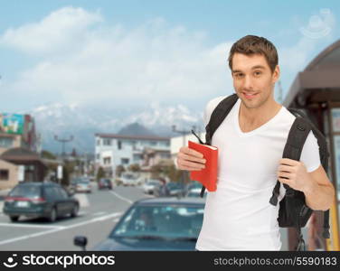 travel, vacation and education concept - travelling student with backpack and book