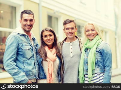 travel, vacation and friendship concept - group of smiling friends in city