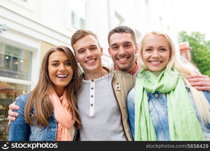 travel, vacation and friendship concept - group of smiling friends in city