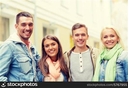 travel, vacation and friendship concept - group of smiling friends in city