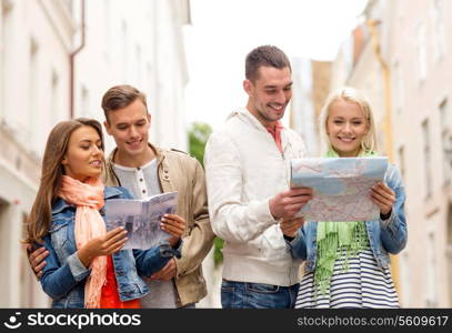 travel, vacation and friendship concept - group of smiling friends with city guide and map exploring city