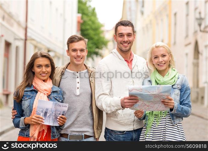 travel, vacation and friendship concept - group of smiling friends with city guide and map exploring city