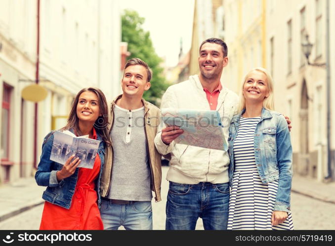 travel, vacation and friendship concept - group of smiling friends with city guide and map exploring city