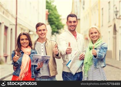travel, vacation and friendship concept - group of smiling friends with city guide and map showing thumbs up in the city