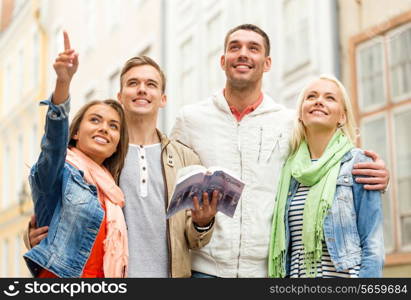 travel, vacation and friendship concept - group of smiling friends with city guide exploring town