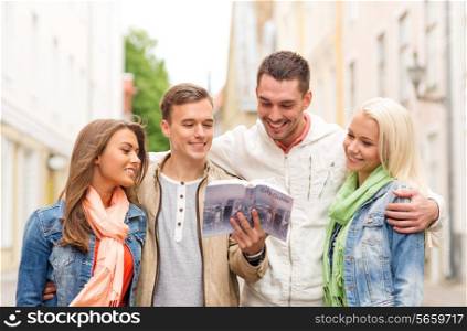 travel, vacation and friendship concept - group of smiling friends with city guide exploring town