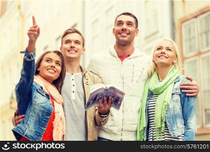 travel, vacation and friendship concept - group of smiling friends with city guide exploring town