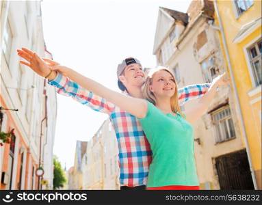 travel, vacation and friendship concept - smiling couple in city