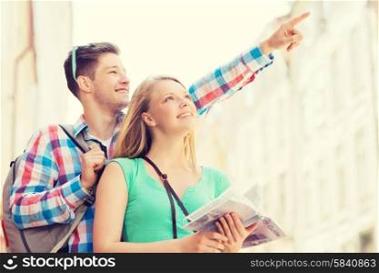 travel, vacation and friendship concept - smiling couple with city guide and backpack in city