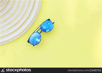 Travel vacation background. Sun glasses hat bright yellow background. Concept summer holidays.. Travel vacation background. Sun glasses yellow background. Concept summer holidays.