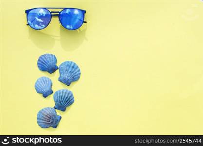Travel vacation background. Sun glasses sea shells bright yellow background. Concept summer holidays.. Travel vacation background. Sun glasses sea shells yellow background. Concept summer holidays.