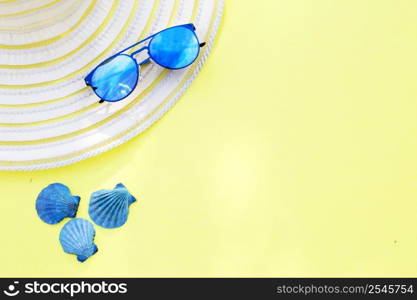 Travel vacation background. Sun glasses sea shells bright yellow background. Concept summer holidays.. Travel vacation background. Sun glasses sea shells yellow background. Concept summer holidays.