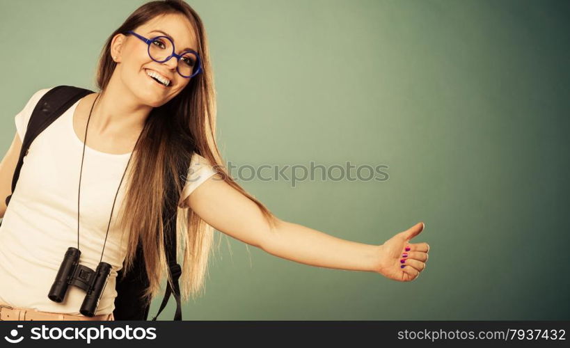 Travel vacation hitchhiking concept. Summer girl thumbing and hitch hiking filtered photo