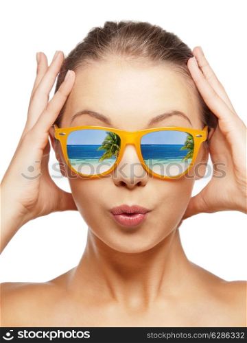 travel, vacation, summer holidays and happy people concept - portrait of amazed teenage girl in sunglasses with beach reflection