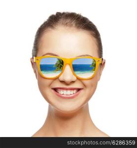 travel, vacation, summer holidays and happy people concept - portrait of happy teenage girl in sunglasses with beach reflection