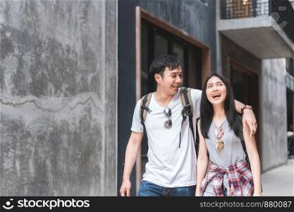 Traveler Asian backpacker couple feeling happy traveling in Beijing, China, cheerful young teenager couple walking at Chinatown. Lifestyle backpack tourist travel holiday in city concept.