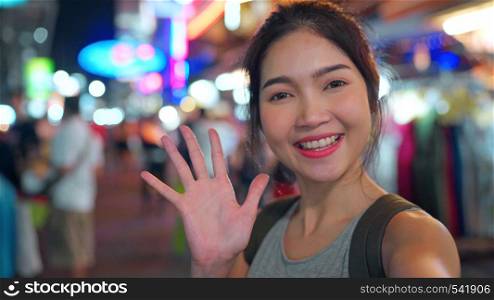 Traveler Asian blogger woman travel in Bangkok, Thailand, beautiful female using mobile phone make vlog and live in social media while hangout at The Khao San Road. Women travel in Thailand concept.