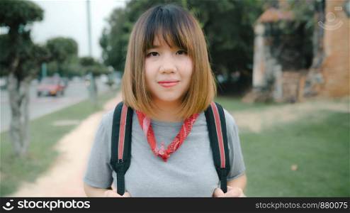 Traveler Asian woman feeling happy smiling to camera holiday trip at Ayutthaya, Thailand, backpacker female enjoy his journey at amazing landmark in traditional city. Lifestyle travel holidays concept