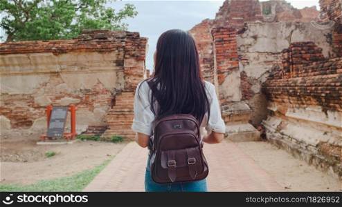 Traveler Asian woman spending holiday trip at Ayutthaya, Thailand, Japanese backpacker female enjoy her journey at amazing landmark in traditional city. Lifestyle women travel holidays concept.