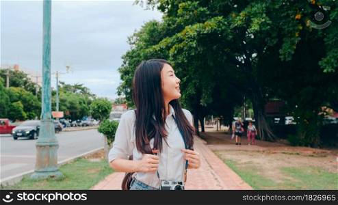 Traveler Asian woman spending holiday trip at Ayutthaya, Thailand, Japanese backpacker female enjoy her journey at amazing landmark in traditional city. Lifestyle women travel holidays concept.
