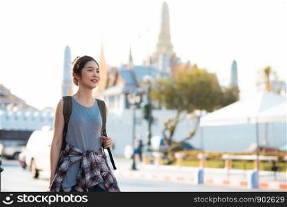 Traveler Asian woman traveling and walking in Bangkok, Thailand, backpacker female feeling happy spending relax time in holiday trip. Lifestyle women travel in Asia city concept.