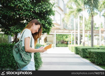 Traveler backpacker asian woman travel in Bangkok, Thailand. Happy young female spending holiday trip at amazing landmark and enjoy her journey in traditional city.