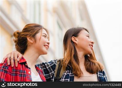Traveler backpacker Asian women lesbian lgbt couple travel in Bangkok, Thailand. Happy young female spending holiday trip at amazing landmark and enjoy her journey in traditional city.