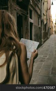 traveler girl looks at the map of walking in Venice, Italy