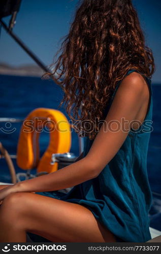 Traveler Girl Tanning on the Sailboat. Luxury Summer Trip to Greece. Recreation on Water Transport. Enjoying Vacation on the Yacht.. Traveler Girl on Sailboat