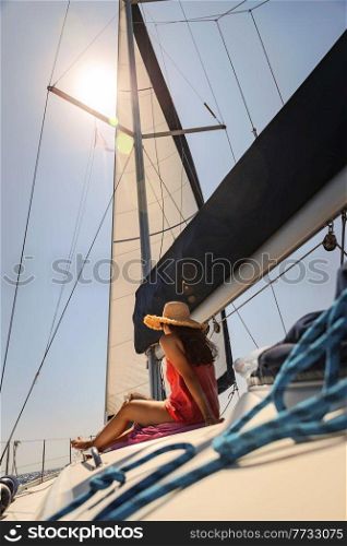 Traveler Girl with Pleasure Reading Book and Tanning on the Sailboat. Luxury Summer Trip to Greece. Enjoying Holidays on the Yacht.. Reading Book on Sailboat