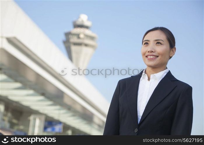 Traveler looking at sky at airport