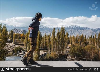 Traveler Man standing and looking view of landscape in Leh Ladakh District ,Norther part of India