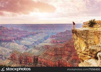 Traveler on cliff mountains over Grand Canyon National Park, Arizona, USA.Inspiring emotion. Travel Lifestyle journey success motivation concept adventure vacations outdoor concept.
