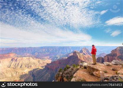 Traveler on cliff mountains over Grand Canyon National Park, Arizona, USA.Inspiring emotion. Travel Lifestyle journey success motivation concept adventure vacations outdoor concept.