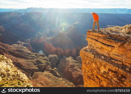 Traveler on cliff mountains over Grand Canyon National Park, Arizona, USA.Inspiring emotion. Travel Lifestyle journey success motivation concept adventure  vacations outdoor concept.