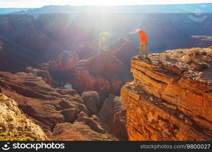 Traveler on cliff mountains over Grand Canyon National Park, Arizona, USA.Inspiring emotion. Travel Lifestyle journey success motivation concept adventure  vacations outdoor concept.