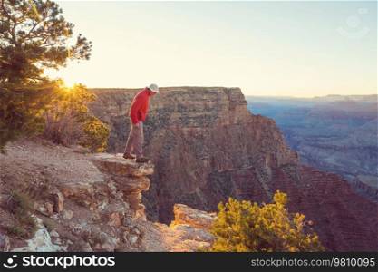 Traveler on cliff mountains over Grand Canyon National Park, Arizona, USA.Inspiring emotion. Travel Lifestyle journey success motivation concept adventure  vacations outdoor concept.