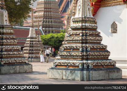 Traveler Walking in the temple. There are a number of smaller stupas.