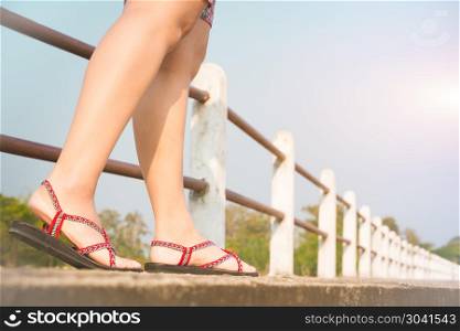 traveler young women on sneakers shoe walking on the bridge on s. traveler young women on sneakers shoe walking on the bridge on sunny day