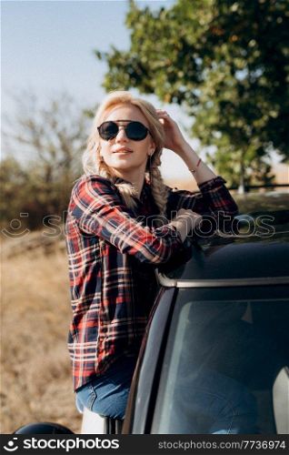 traveling by car of a young couple of a guy and a girl in plaid shirts