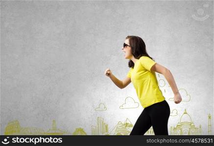 Traveling concept. Young woman in yellow shirt against sketch background