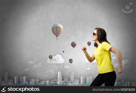 Traveling concept. Young woman in yellow shirt against sketch background