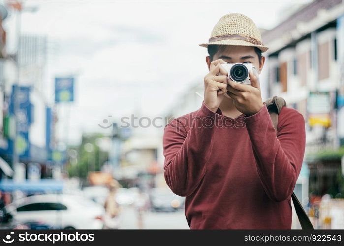 Traveling male tourist backpackers taking photo. City travel and travel concept.