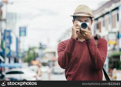 Traveling male tourist backpackers taking photo. City travel and travel concept.