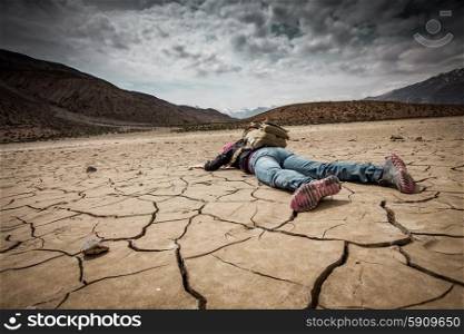 Traveller lays on the dried ground