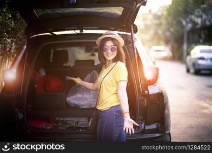 traveller woman toothy smiling face happiness emotion standing on back of suv car ready for road trip on vacation time