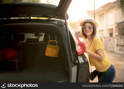 traveller woman toothy smiling face happiness emotion standing on back of suv car ready for road trip on vacation time